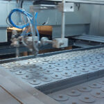 Flat bed chemosil spray paint application to vibration dampers with logo